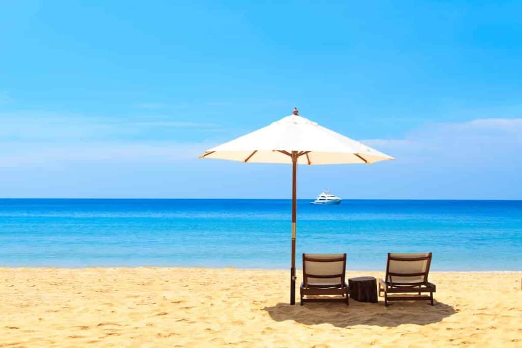 adjustable beach umbrella on the sand with anchor