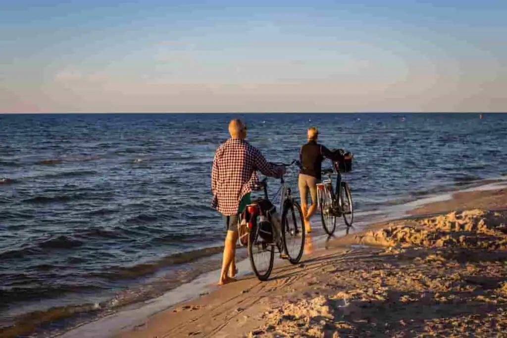 best romantic beach couple activities bicycling together on the beach