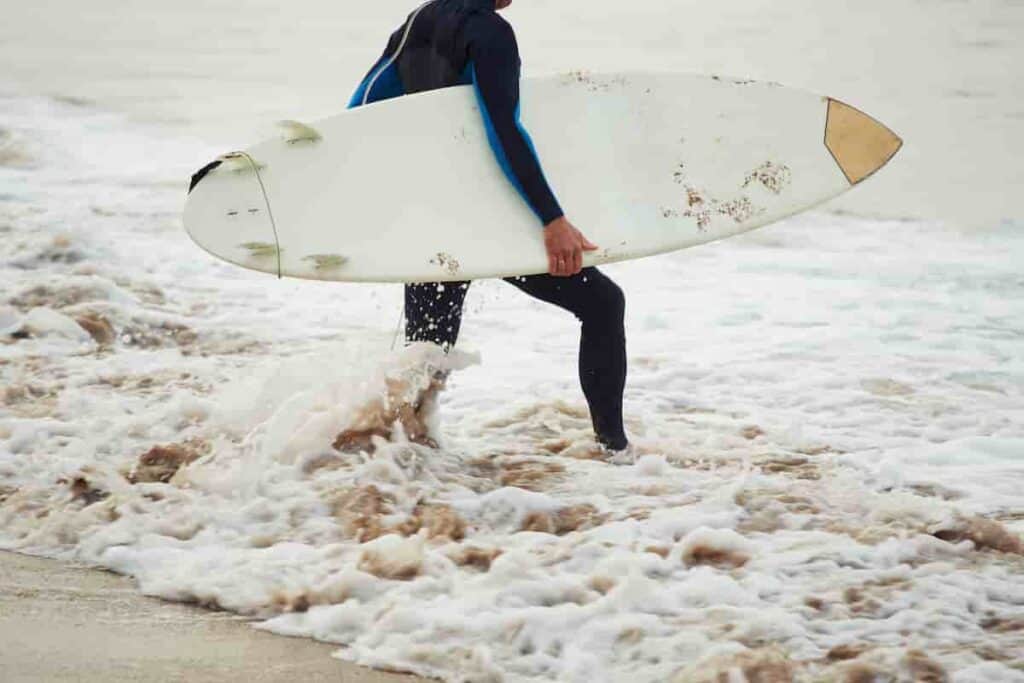 a wetsuit for surfing is proper outfit for cold days at the beach