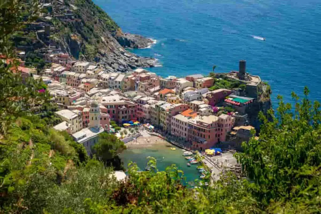 houses on a mountain landscape leading to the blue sea in Italy, 21 Best Beach Towns Near Milan- Surprising Charm of Coastal Villages [Maps Plus Best Beach Near Milan], beach towns near milan, beaches near milan, milan beaches, best beach towns in italy, beach near milan, seaside towns in italy, milan beach