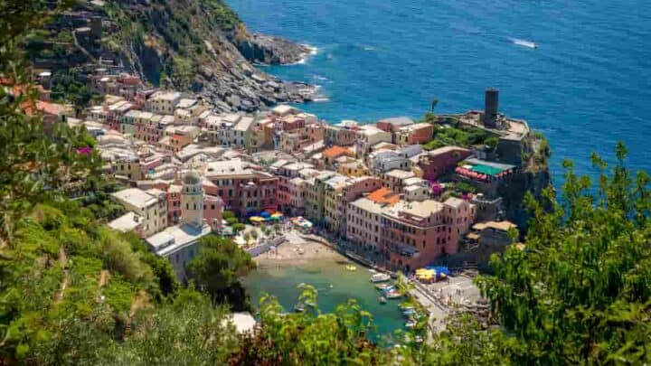 houses on a mountain landscape leading to the blue sea in Italy, 21 Best Beach Towns Near Milan- Surprising Charm of Coastal Villages [Maps Plus Best Beach Near Milan]