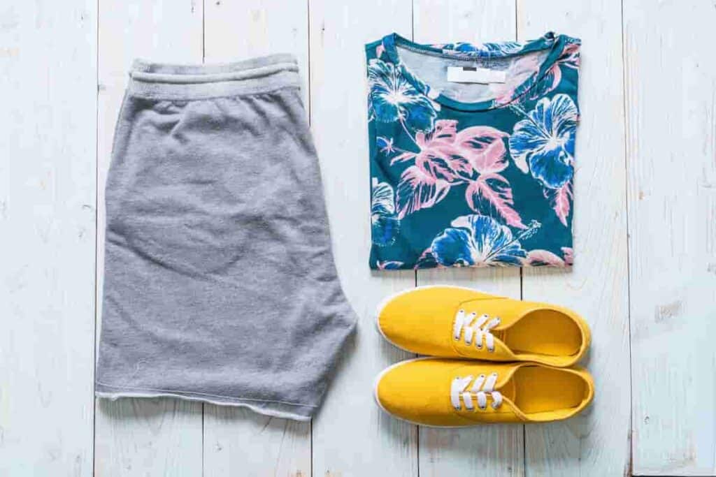 Gray shorts and flower top and yellow shoes, 11 Beach Travel Essentials to Pack – Minimalist Approach [Plus Packing List], UV-Protection Essentials, essential beach items, Beach Footwear Choices, Minimalist Beach Packing, minimalist packing for beach vacation, Water-Resistant Tech Gear, beach trip essentials