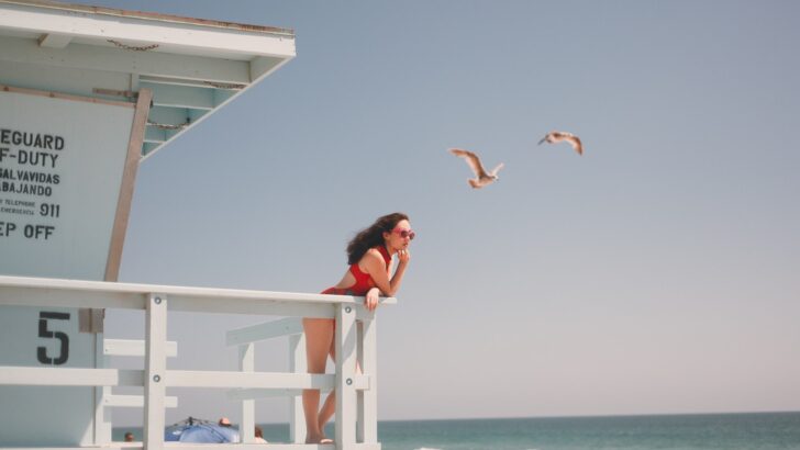 Photo Of Woman Leaning On Wooden Fence