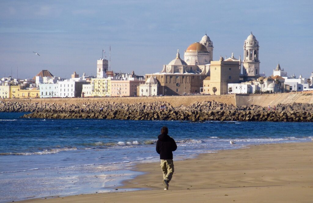 cadiz, beach, cathedral in the background, 11 Best Andalucia Beach Towns-Costa del Sol Beaches [Playa] Southern Spain, costa tropical towns, best beach towns in Spain, best beach towns Andalucia, best andalucia beach towns, beach towns in Spain, best beach towns in Andalucia, best beaches in southern Spain