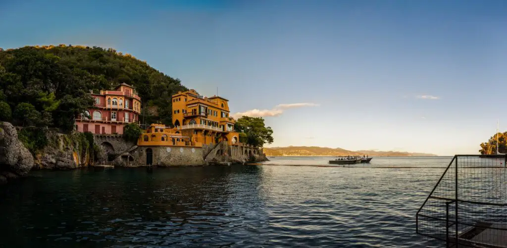 a building on a rocky island, 21 Best Beach Towns Near Milan- Surprising Charm of Coastal Villages [Maps Plus Best Beach Near Milan], beaches near milan, best beach towns in italy, beach towns near milan, milan beach, beach near milan, milan beaches, seaside towns in italy
