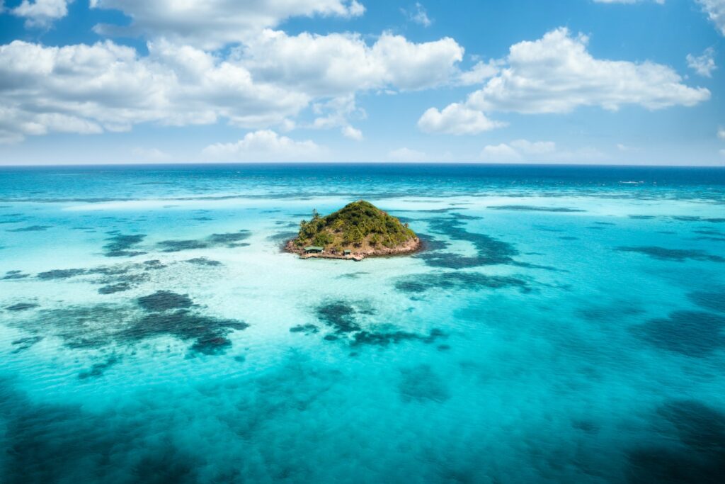 landscape photography of sea with little island between, 9 Colombian Beach Towns- [Surprising Beautiful] Caribbean Coast Cities With Beaches in Colombia, beach cities in colombia, colombia beach towns, colombia coastal cities, best beach towns in colombia, colombian caribbean coast, beach towns in colombia, best beaches in colombia
